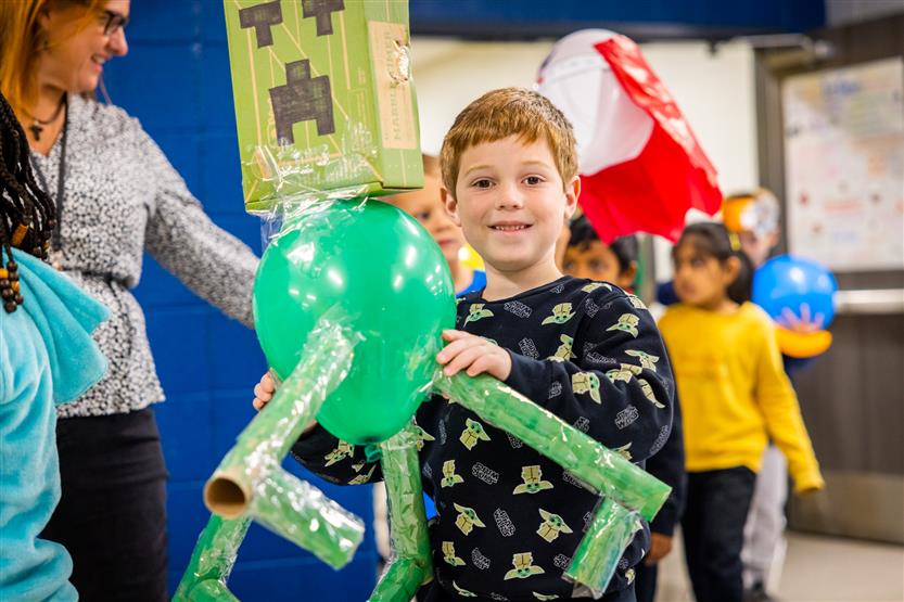 Students participate in a balloon parade